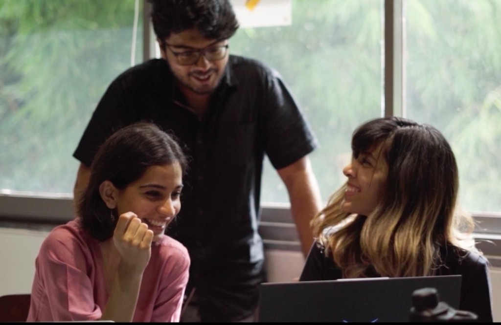 Three people collaborating at laptops